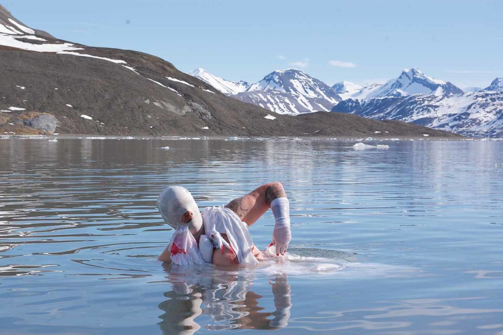 Linda Stupart emerges from an icy lake