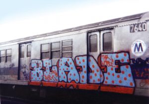 BLADE spray painted on the side of a subway car