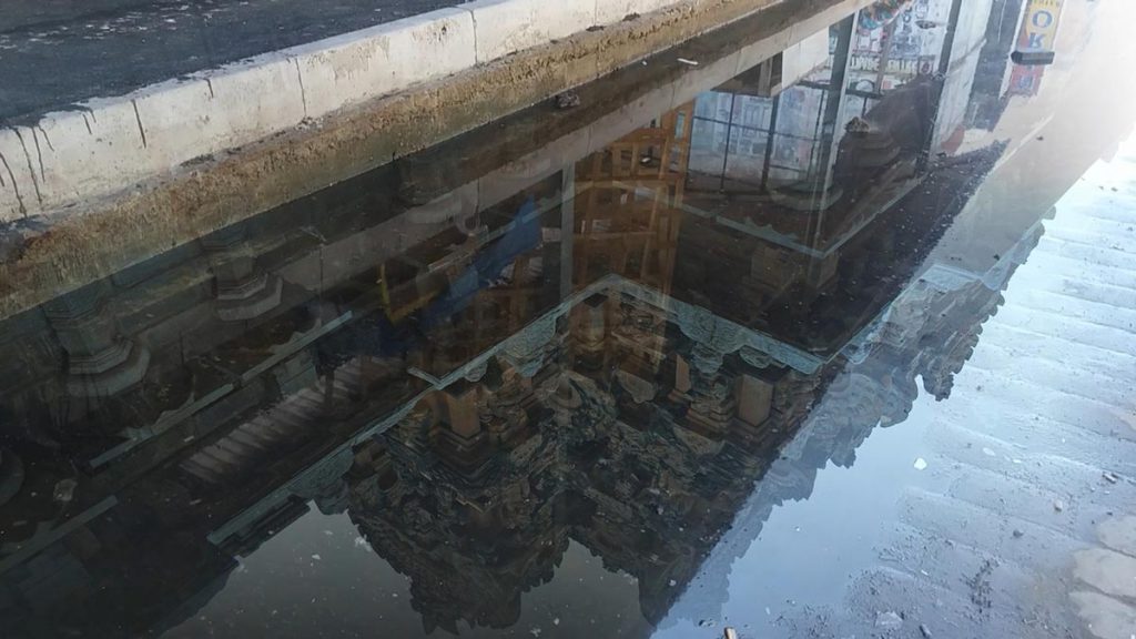 A cityscape as reflected in a puddle
