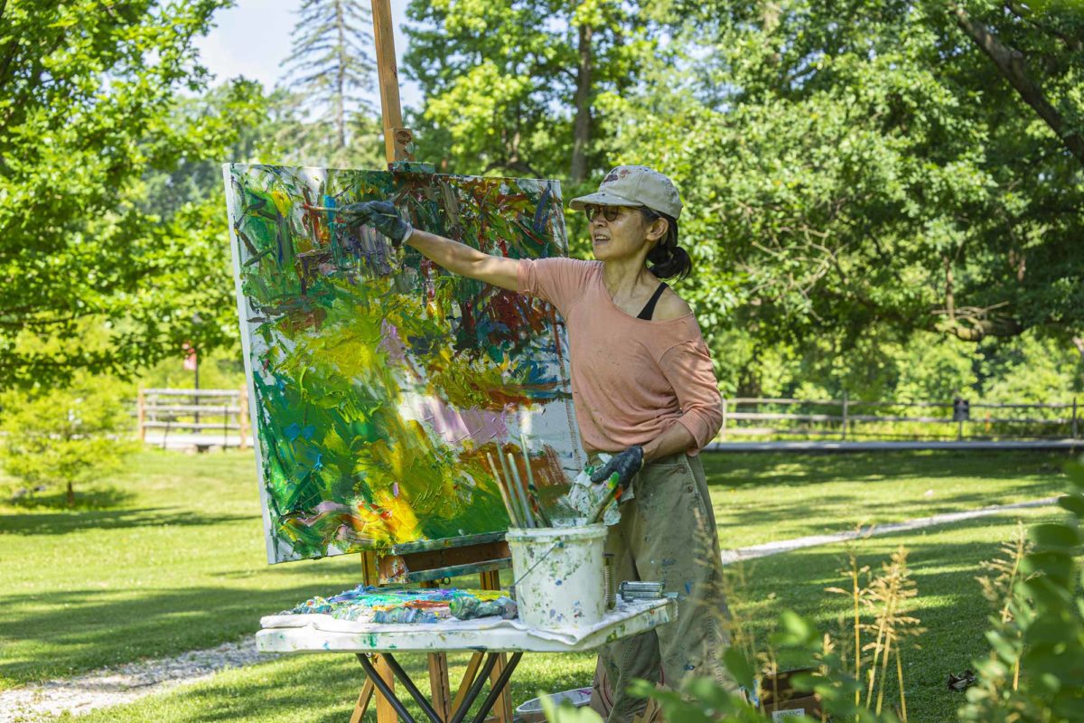 Ying Li painting outdoors on Haverford's campus