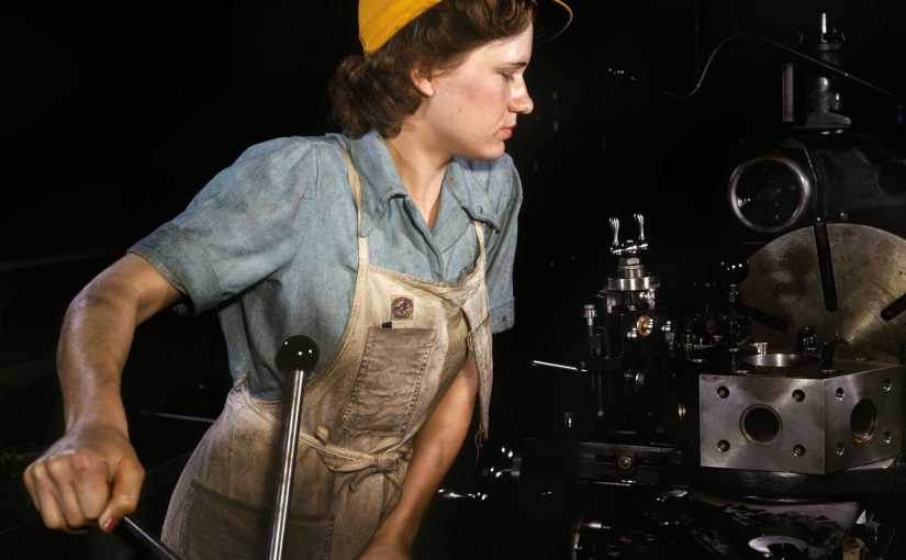 A woman operating a lathe