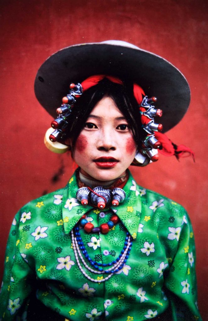 A Tibetan woman wearing bold makeup and jewlery