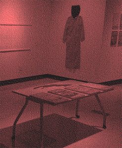 A kimono hanging on a wall with a table in the foreground