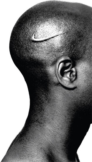 An African American male with a Nike swoosh branded to his shaved head.