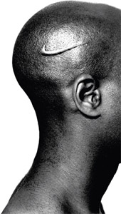 An African-American male with a Nike swoosh branded to his shaved head.