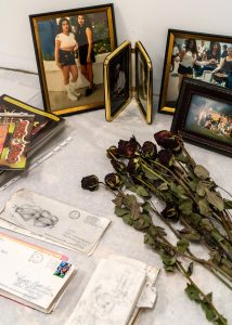 Photos, flowers, and letters forming a shrine