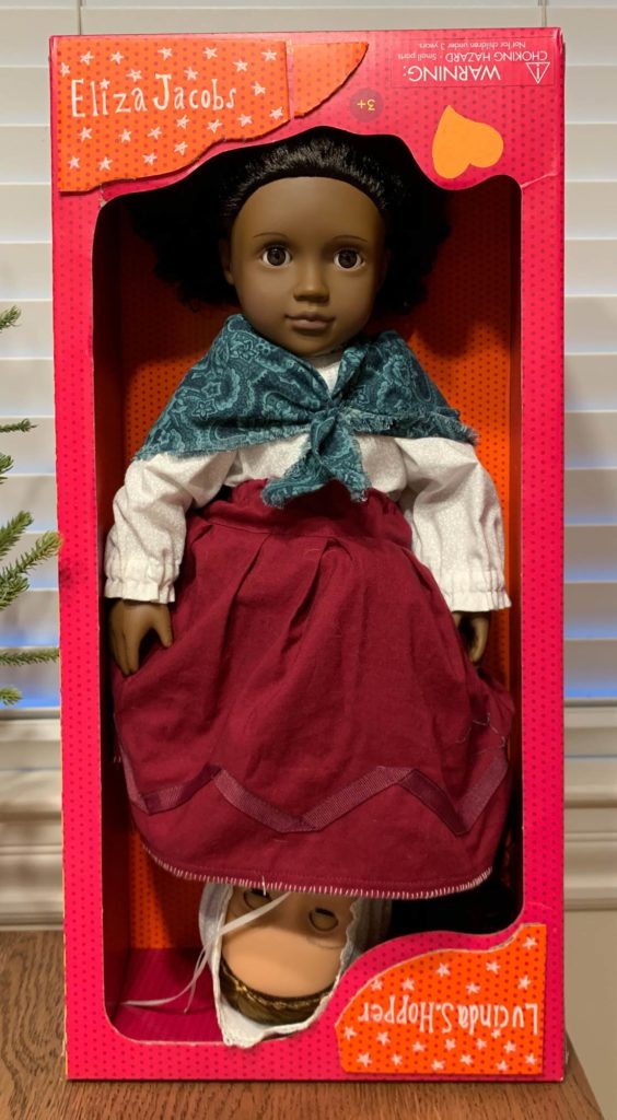 a double sided doll with a skirt that lets you switch between Eliza Jacobs and Lucinda Hopper