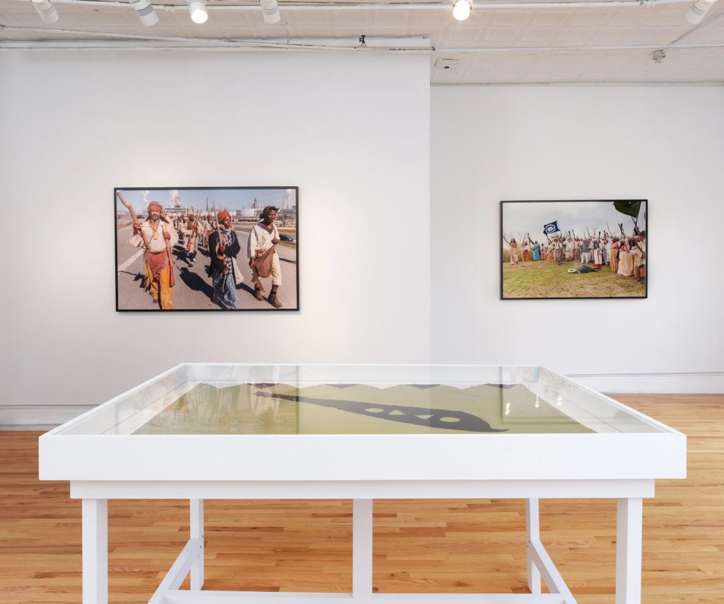 installation shot of photographs from the reenactment on display