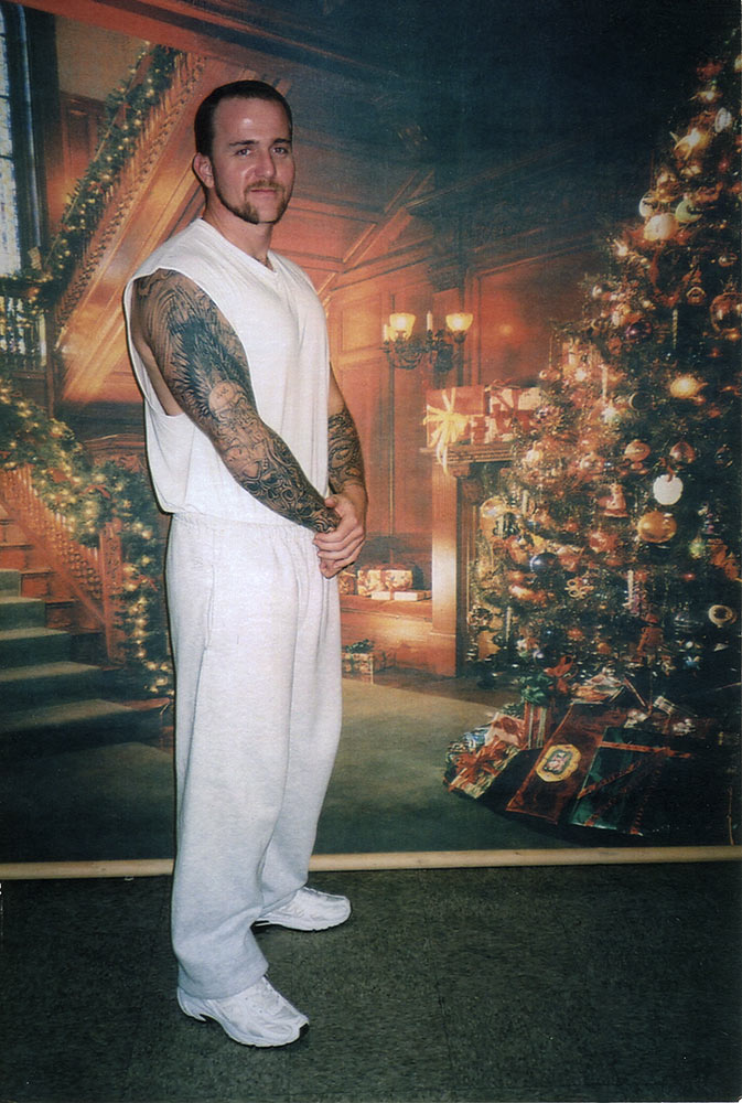Prisoner Brandon Jones stands in front of a faux Christmas backdrop.