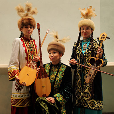 Central Asian musicians in traditional garb with instruments